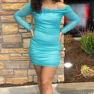 It’s more turquoise in person super glittery tight dress. In a Size medium!